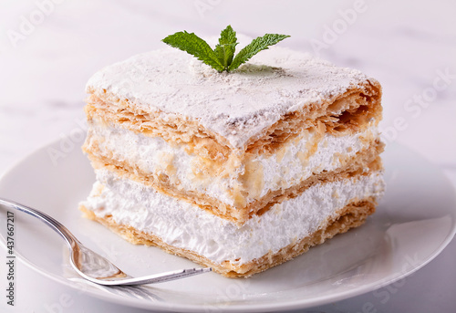 Mille-feuille with meringue on white background photo