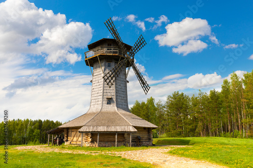 Wooden windmill on background sky with clouds. Naroch lake, Myadel Region, Belarus photo
