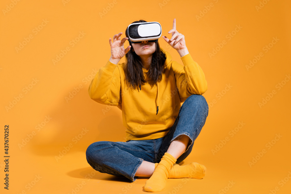 Immersion in cyberspace, virtual reality and the user. A gamer in a yellow hoodie Immersion in cyberspace, virtual reality and the user. A gamer in a yellow hoodie