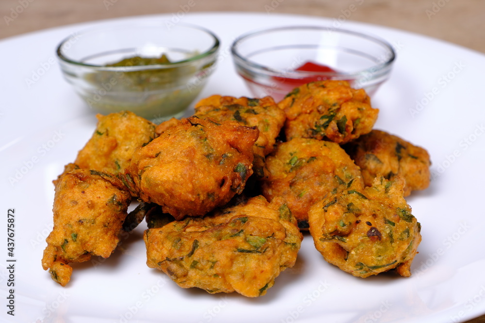 Indian snack pakora with tomato sauce or chutney Indian snack pakora with tomato sauce or chutney
