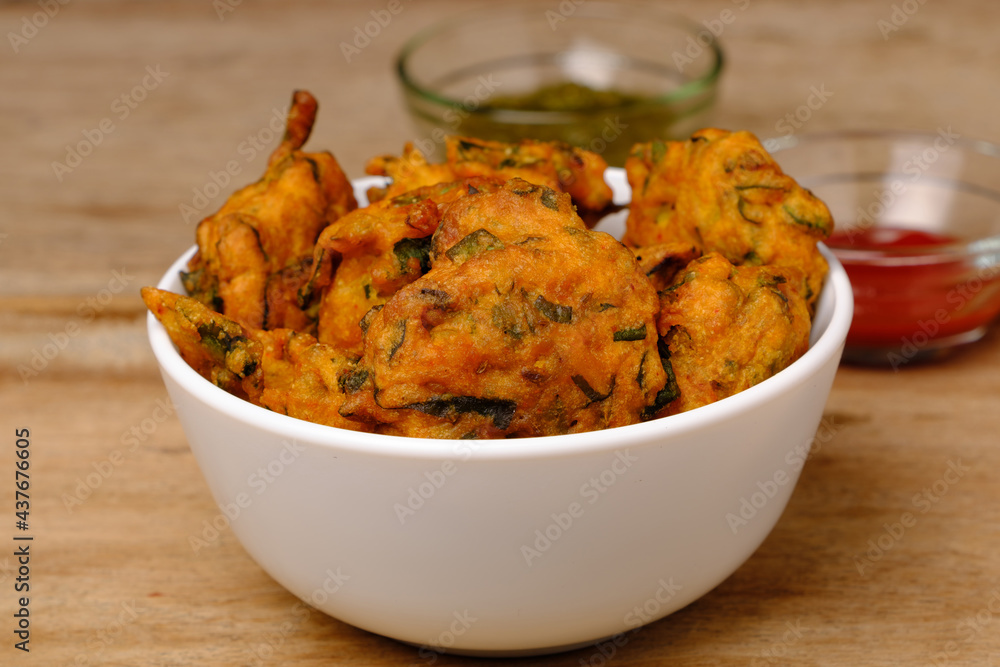 Indian snack pakora with tomato sauce or chutney Indian snack pakora with tomato sauce or chutney
