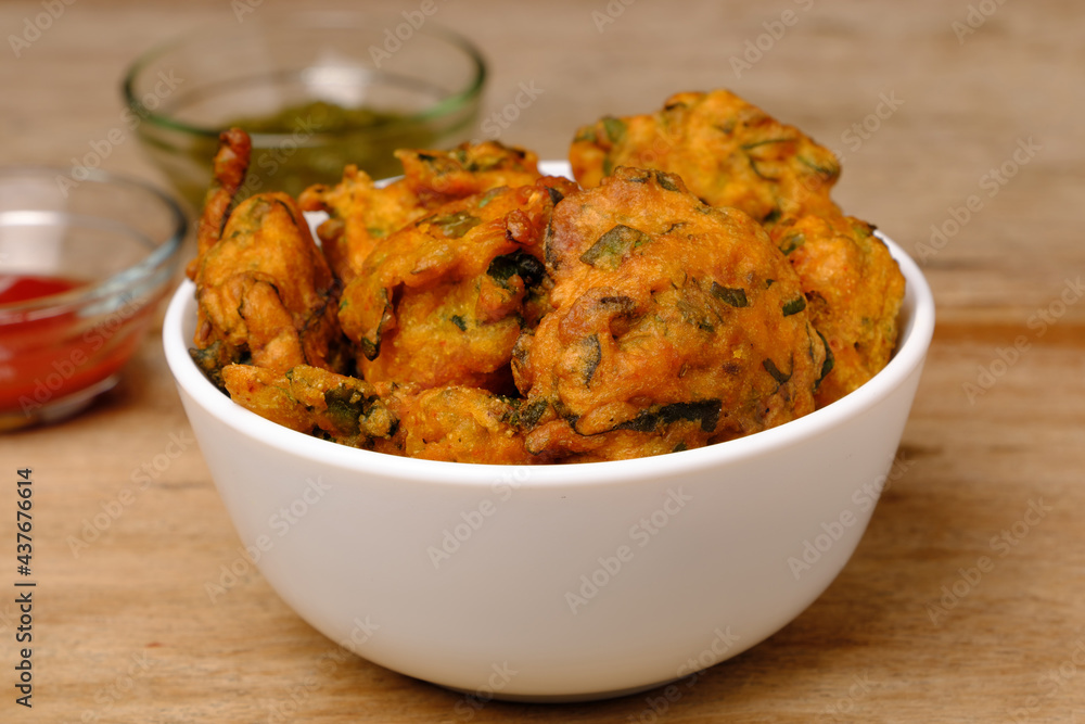 Indian snack pakora with tomato sauce or chutney Indian snack pakora with tomato sauce or chutney