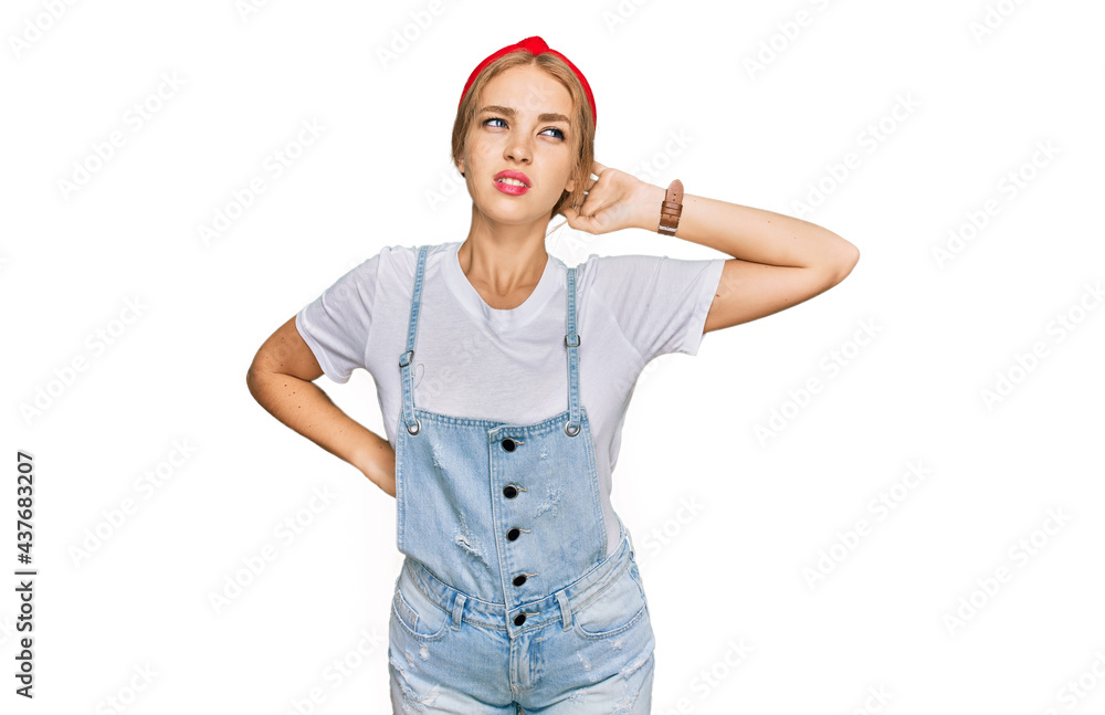 Young caucasian girl wearing casual clothes suffering of neck ache injury, touching neck with hand, muscular pain Young caucasian girl wearing casual clothes suffering of neck ache injury, touching neck with hand, muscular pain