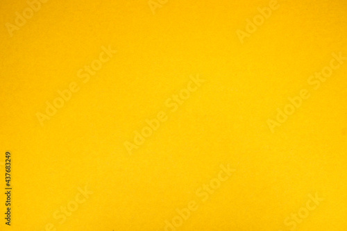 Yellow background. The texture of the cardboard.