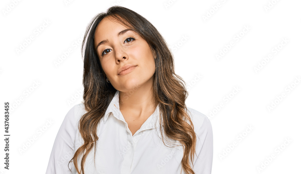 Young brunette woman wearing casual clothes relaxed with serious expression on face. simple and natural looking at the camera. Young brunette woman wearing casual clothes relaxed with serious expression on face. simple and natural looking at the camera.