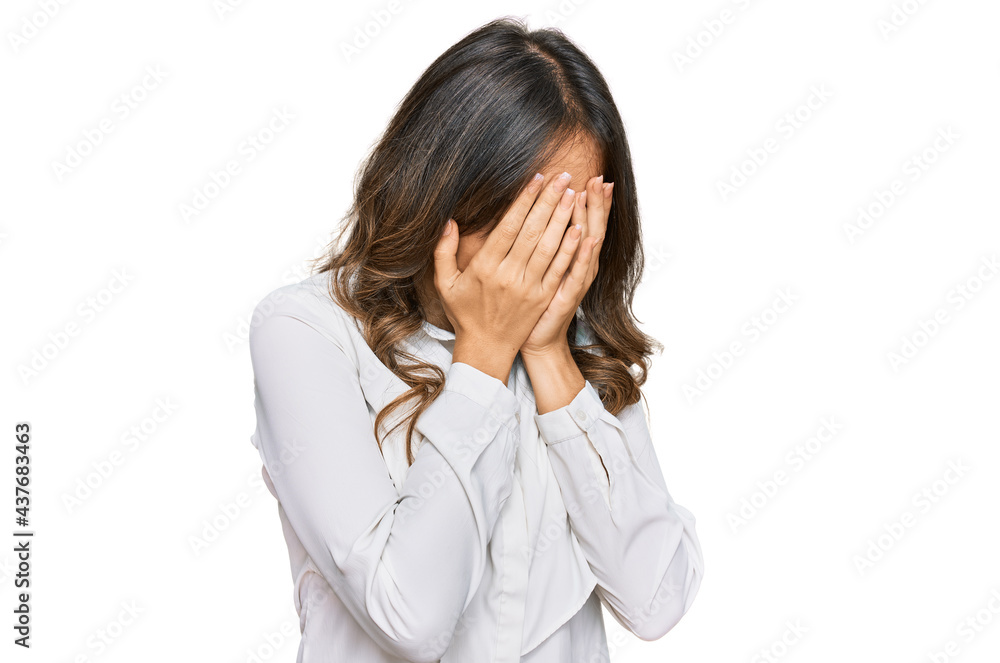 Young brunette woman wearing casual clothes with sad expression covering face with hands while crying. depression concept. Young brunette woman wearing casual clothes with sad expression covering face with hands while crying. depression concept.