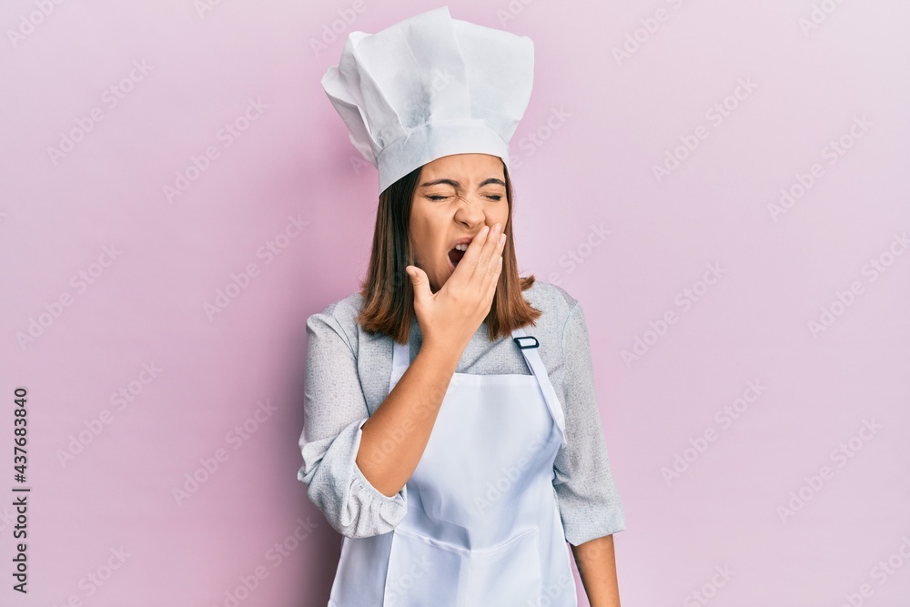 Young beautiful woman wearing professional cook uniform and hat bored yawning tired covering mouth with hand. restless and sleepiness. Young beautiful woman wearing professional cook uniform and hat bored yawning tired covering mouth with hand. restless and sleepiness.
