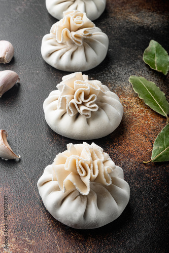 Stuffed dumplings, manti of dough and minced , on old dark rustic background