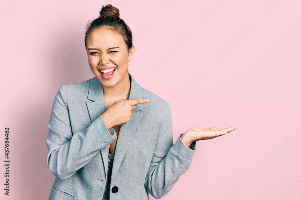 Young hispanic girl pointing open palm with finger winking looking at the camera with sexy expression, cheerful and happy face. Young hispanic girl pointing open palm with finger winking looking at the camera with sexy expression, cheerful and happy face.