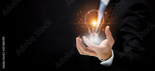 business hand holding illuminated light bulb, icon, innovation and inspiration concept.concept of creativity with bulbs that shine glitter, creativity with bulbs that shine glitter.Inspiration of idea