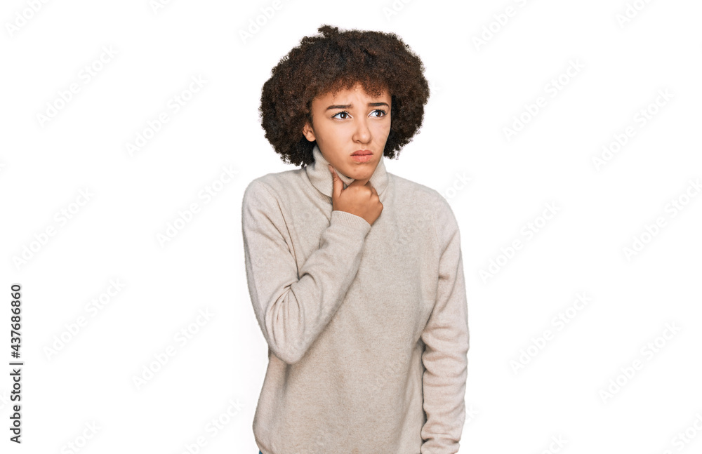 Young hispanic girl wearing wool winter sweater touching painful neck, sore throat for flu, clod and infection Young hispanic girl wearing wool winter sweater touching painful neck, sore throat for flu, clod and infection