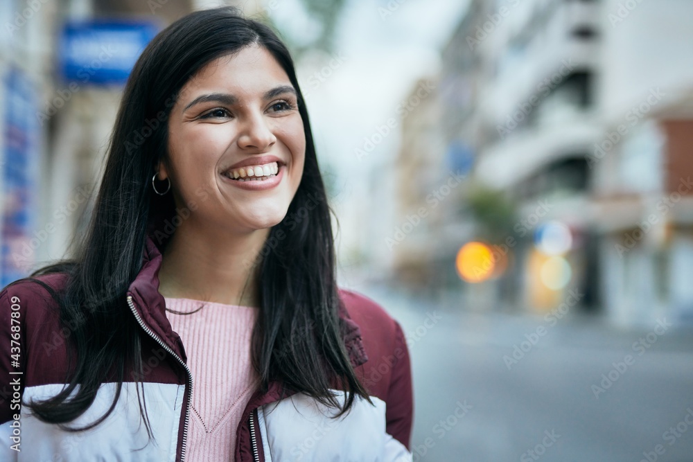 Young hispanic girl smiling happy standing at the city. Young hispanic girl smiling happy standing at the city.