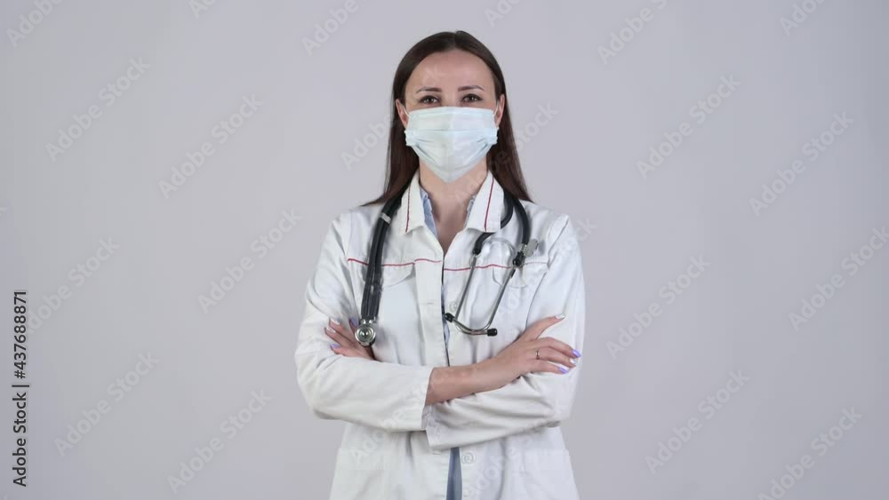 Portrait of smiling female doctor in surgical mask medical Uniform looking at camera with stethoscope isolated on white background. Health care and medical concept. Medical workers. Portrait of smiling female doctor in surgical mask medical Uniform looking at camera with stethoscope isolated on white background. Health care and medical concept. Medical workers.
