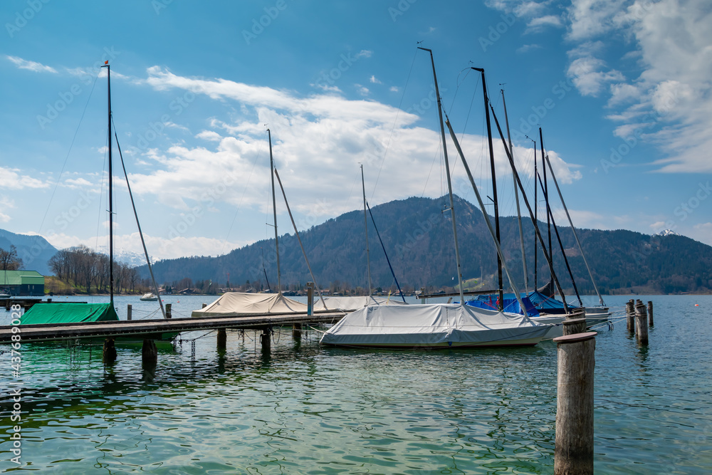 Beautiful alpine view with boats and reflections at the famous Tegernsee, Bavaria, Germany. 