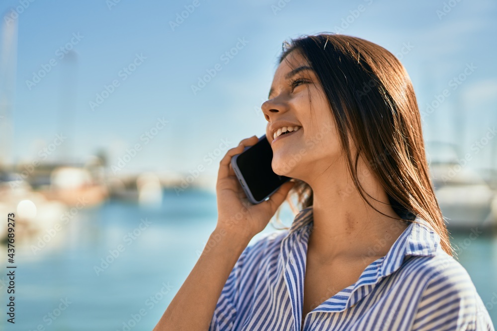 Young hispanic girl smiling happy talking on the smartphone at the port Young hispanic girl smiling happy talking on the smartphone at the port