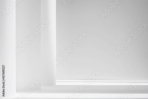 Abstract white studio background for product presentation. Empty gray room with shadows of window. Display product with blurred backdrop.