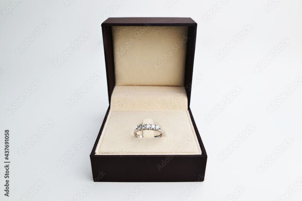 Women's diamond ring (Eternity ring) in a box. White Gold and Diamond Engagement Ring in a black box. Diamond rings in a box. Box with luxury engagement ring on light background. Women's diamond ring (Eternity ring) in a box. White Gold and Diamond Engagement Ring in a black box. Diamond rings in a box. Box with luxury engagement ring on light background.