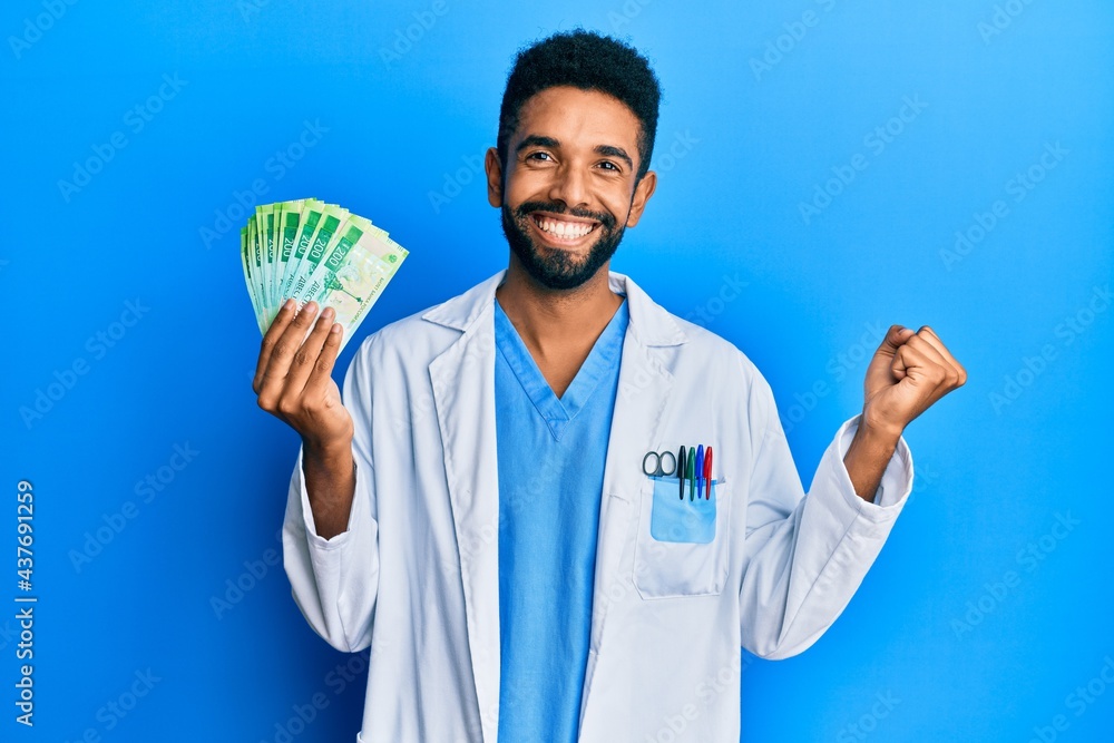 Handsome hispanic man with beard wearing medical uniform holding 200 russian ruble screaming proud, celebrating victory and success very excited with raised arm Handsome hispanic man with beard wearing medical uniform holding 200 russian ruble screaming proud, celebrating victory and success very excited with raised arm