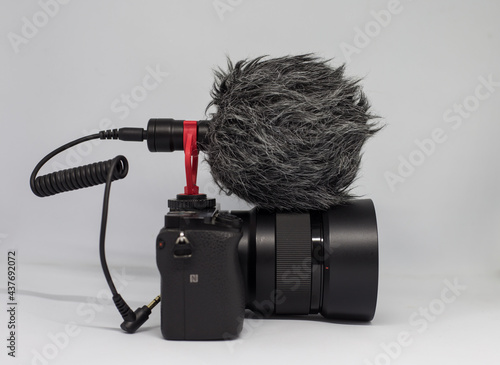 Shotgun mic on mirrorless camera isolated on white background. 