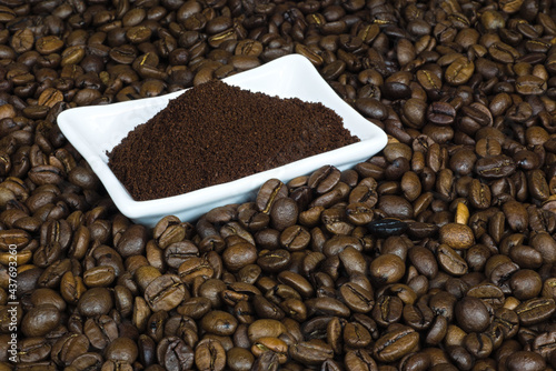 spilled coffee beans with a white bowl