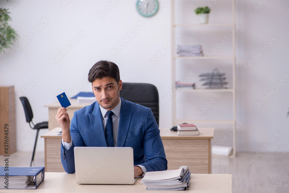 Young male employee sitting in the office