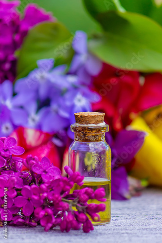 Flower Buzz Collection Flower essential oil. Lilac essential oil in a bottle. Selective focus