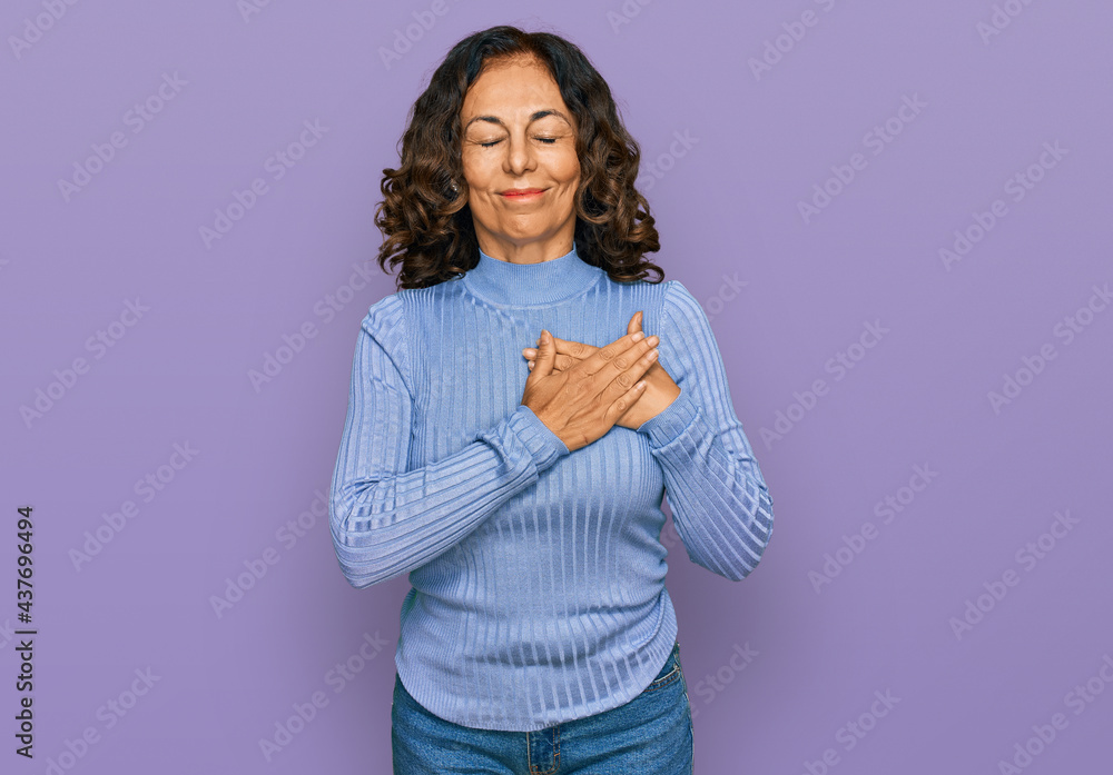 Middle age hispanic woman wearing casual clothes smiling with hands on chest with closed eyes and grateful gesture on face. health concept. Middle age hispanic woman wearing casual clothes smiling with hands on chest with closed eyes and grateful gesture on face. health concept.