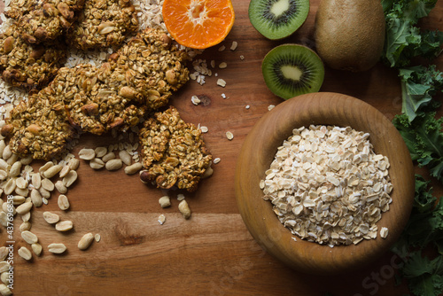 healthy food fruit grains lettuce leaves on wooden background flat lay