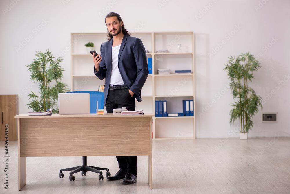 Young male employee working in the office