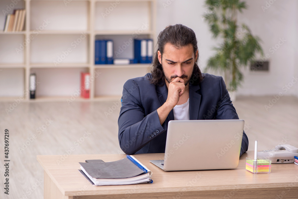 Young male employee working in the office Young male employee working in the office
