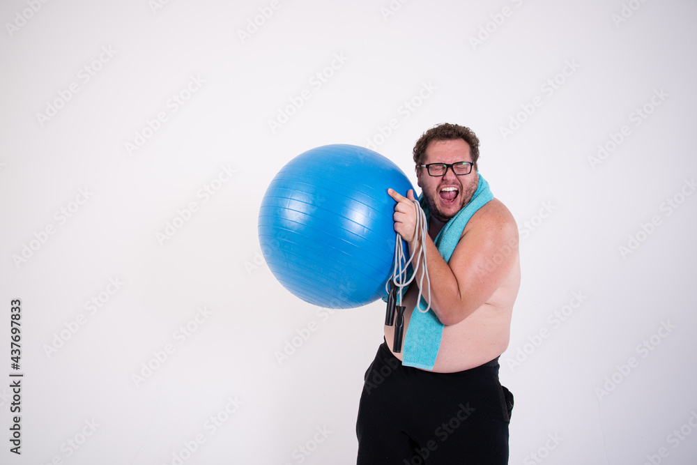 Funny fat man is engaged in fitness. Funny fat man is engaged in fitness.