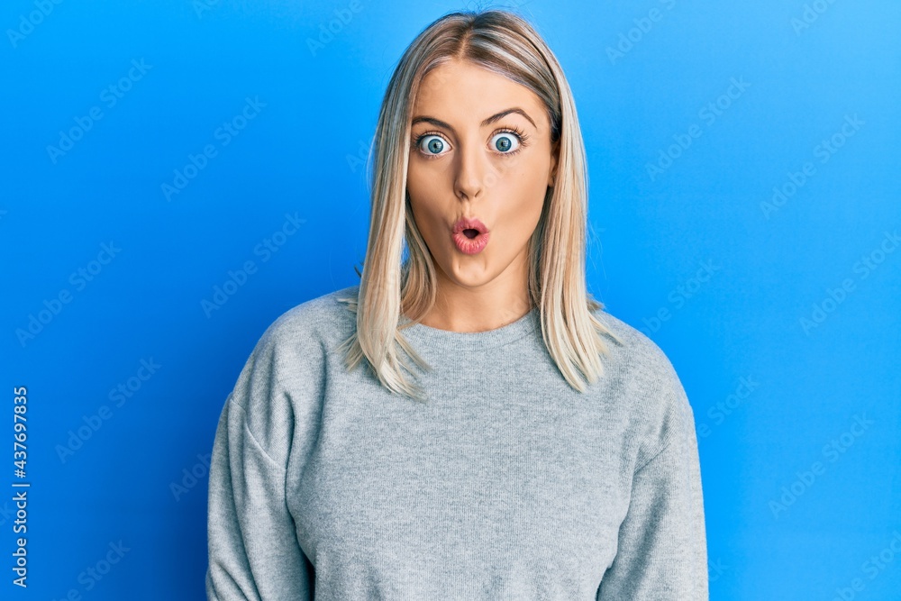 Beautiful blonde woman wearing casual clothes afraid and shocked with surprise expression, fear and excited face. Beautiful blonde woman wearing casual clothes afraid and shocked with surprise expression, fear and excited face.