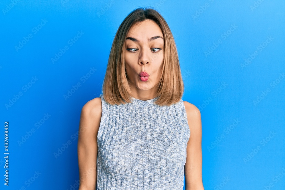Young caucasian blonde woman wearing casual t shirt making fish face with lips, crazy and comical gesture. funny expression. Young caucasian blonde woman wearing casual t shirt making fish face with lips, crazy and comical gesture. funny expression.