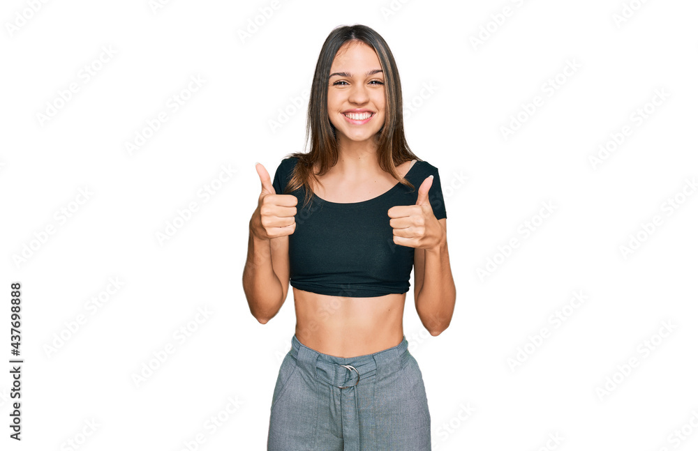 Young brunette woman wearing casual clothes success sign doing positive gesture with hand, thumbs up smiling and happy. cheerful expression and winner gesture. Young brunette woman wearing casual clothes success sign doing positive gesture with hand, thumbs up smiling and happy. cheerful expression and winner gesture.