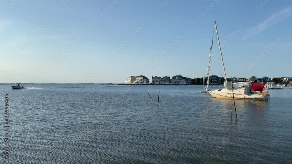 waterfront homes and boat port on a nice summer day with speed boat waterfront homes and boat port on a nice summer day with speed boat