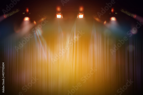 blurred empty theater stage with fun colourful spotlights, abstract image of concert lighting illumination background