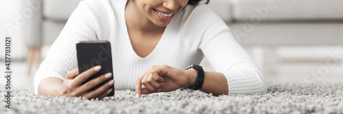 African american woman using smartwatch with e-mail notifier, connecting smartphone to modern hand device, panorama