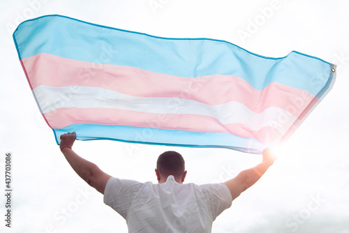 Transgender man holding waving transgender flag, concept picture about human rights, equality in the World photo