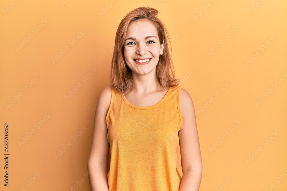 Young caucasian woman wearing casual style with sleeveless shirt with a happy and cool smile on face. lucky person. Young caucasian woman wearing casual style with sleeveless shirt with a happy and cool smile on face. lucky person.