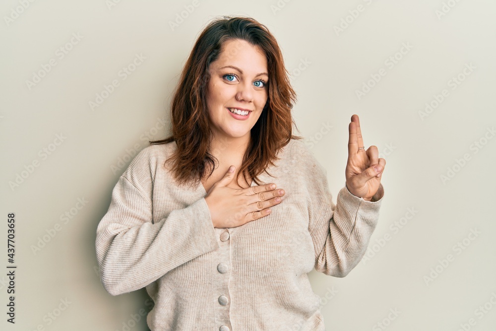 Young caucasian woman wearing casual clothes smiling swearing with hand on chest and fingers up, making a loyalty promise oath Young caucasian woman wearing casual clothes smiling swearing with hand on chest and fingers up, making a loyalty promise oath