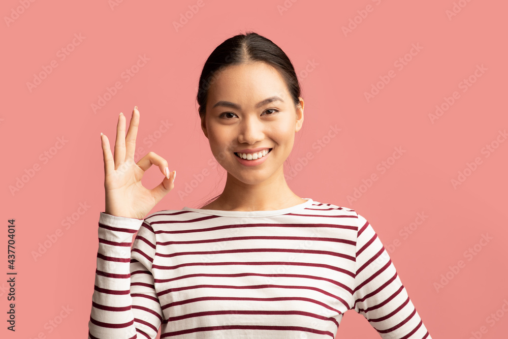 It's Ok. Cheerful Young Asian Lady Showing Okay Gesture At Camera