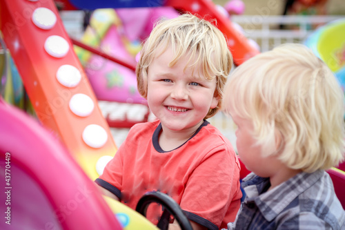 Happy caucasian boy smiling on ride at country show photo