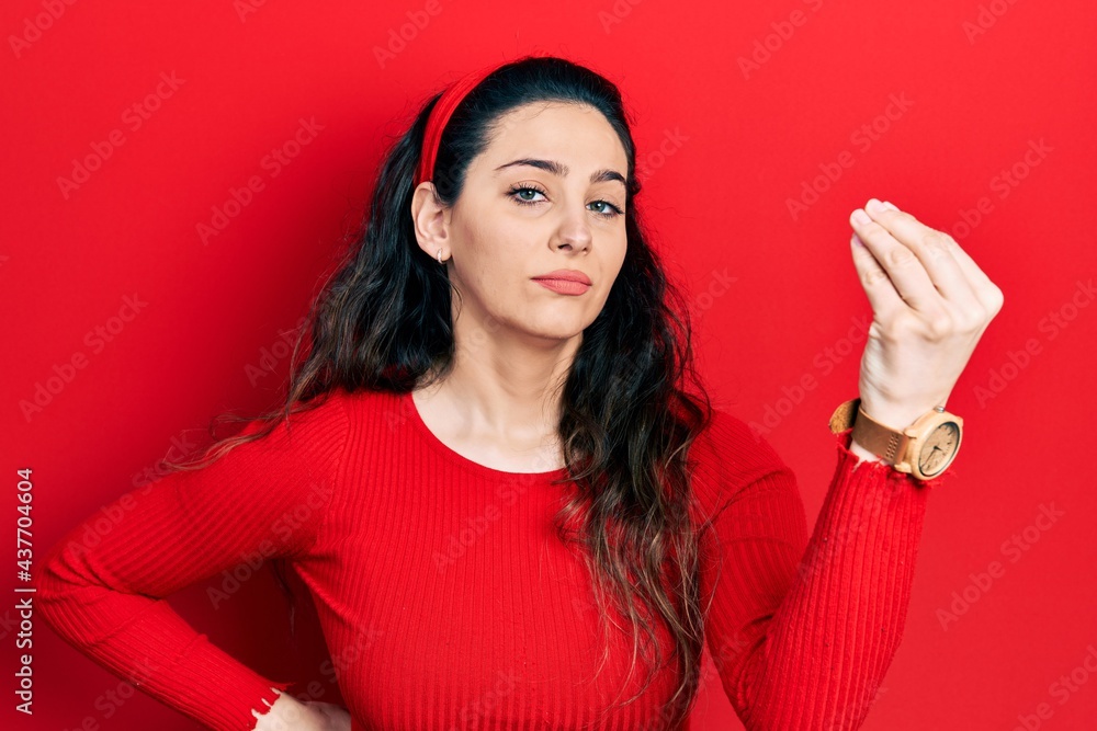 Young hispanic woman wearing casual clothes doing italian gesture with hand and fingers confident expression Young hispanic woman wearing casual clothes doing italian gesture with hand and fingers confident expression