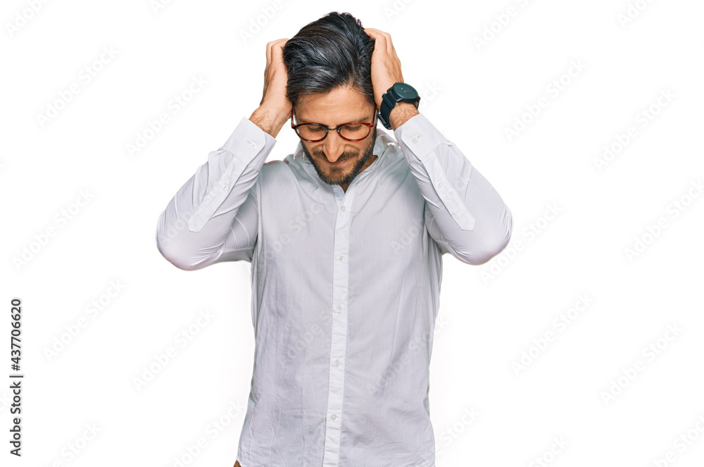 Young hispanic man wearing business shirt and glasses suffering from headache desperate and stressed because pain and migraine. hands on head. Young hispanic man wearing business shirt and glasses suffering from headache desperate and stressed because pain and migraine. hands on head.
