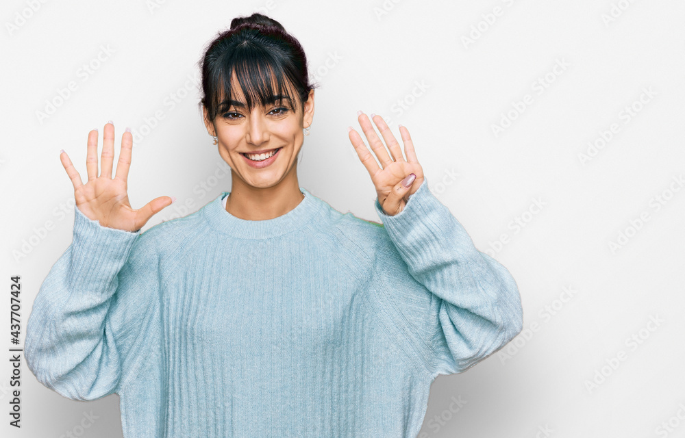 Young hispanic woman wearing casual clothes showing and pointing up with fingers number nine while smiling confident and happy.