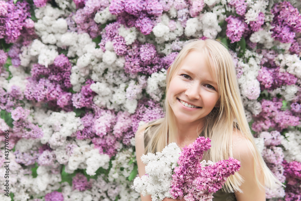 happy young woman with a bouquet on a background of blooming lilacs happy young woman with a bouquet on a background of blooming lilacs