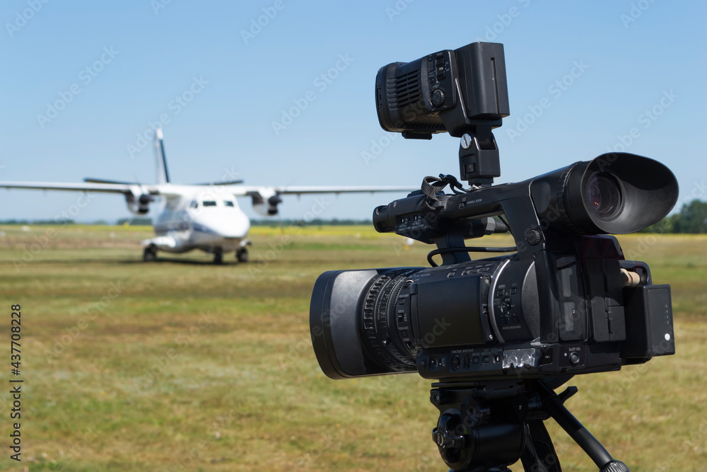 Camcorder against a blurred background with an airplane Camcorder against a blurred background with an airplane