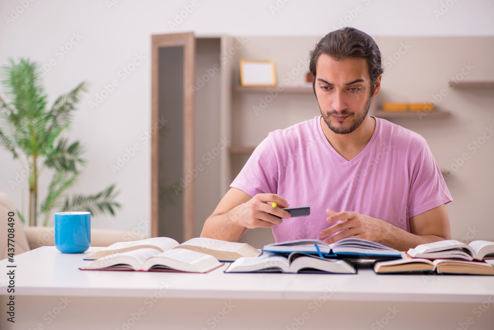 Young male student preparing for exams at home Young male student preparing for exams at home