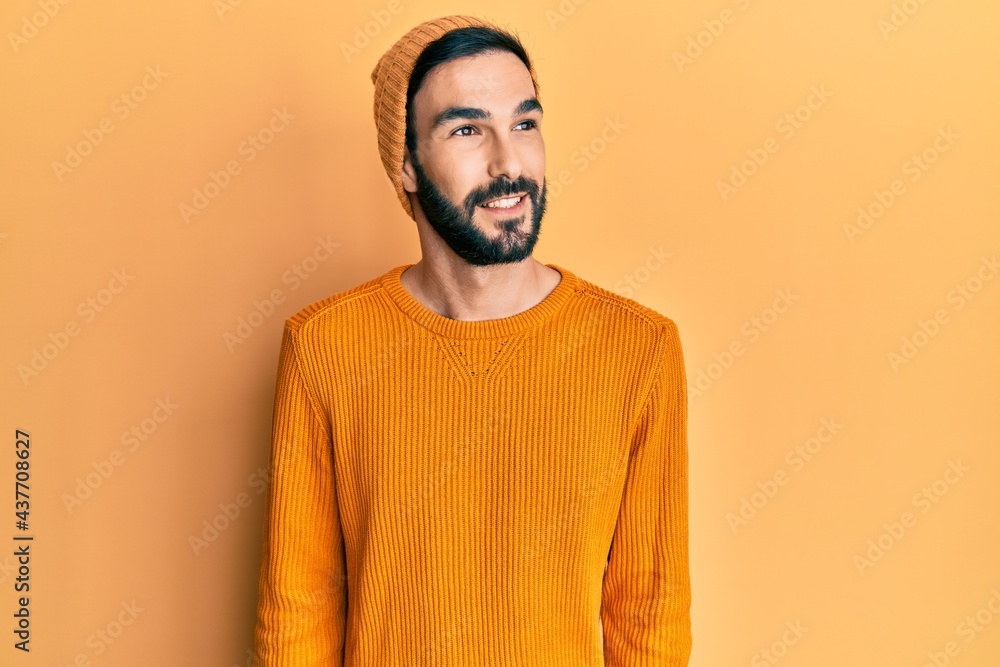 Young hispanic man wearing casual clothes looking to side, relax profile pose with natural face and confident smile. Young hispanic man wearing casual clothes looking to side, relax profile pose with natural face and confident smile.
