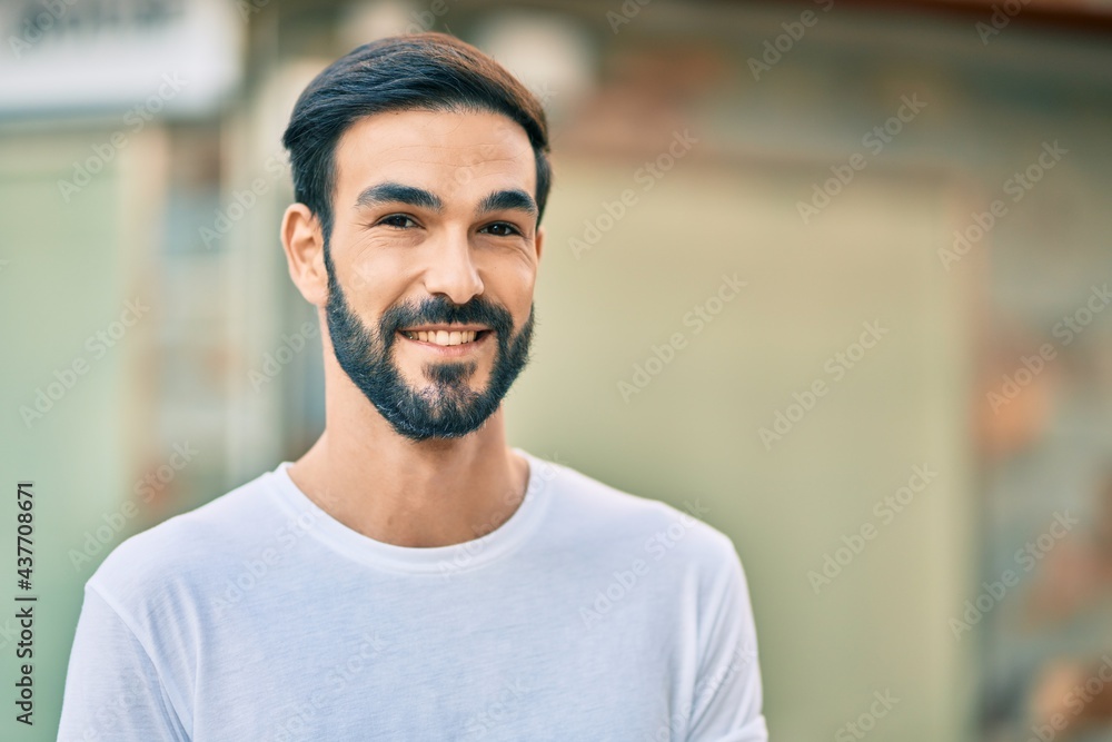 Young hispanic man smiling happy standing at the city. Young hispanic man smiling happy standing at the city.